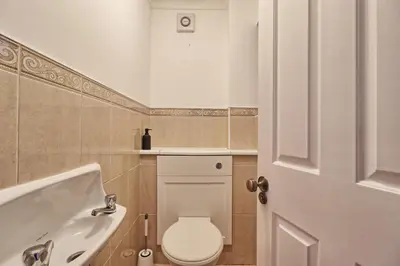 a bathroom with a toilet and a bath tub at Stylish 5-Bed London Residence Featuring Garden, Parking & High-Speed Internet in Nevendon