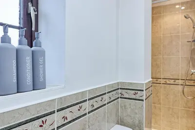 a bathroom with two oxygen bottles on a shelf at Stylish 5-Bed London Residence Featuring Garden, Parking & High-Speed Internet in Nevendon