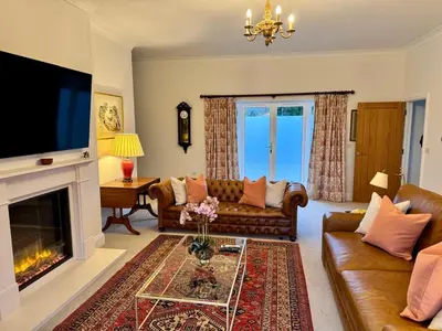 a living room with a couch and a fireplace at North Farm fits 1-6 people in Sawston