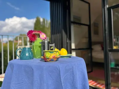 a table with a blue table cloth and a vase with flowers at Crown Lodge, Great Glemham in Saxmundham