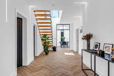 a hallway with a staircase in a house at House of Hertfordshire in Datchworth
