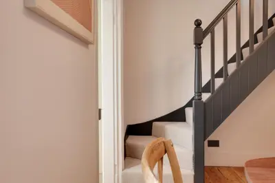 a staircase in a home with black and white stairs at Luxury Two Bedroom Cottage - Bishops Stortford in Bishops Stortford