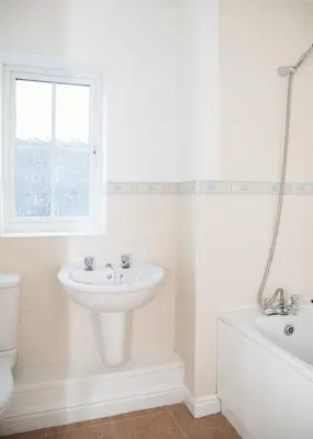a white bathroom with a sink and a bath tub at 4x Bed Elegant Home with Parking in Ely