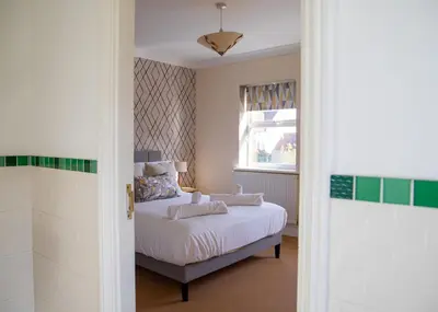 a bedroom with a bed and a window at 4x Bed Elegant Home with Parking in Ely