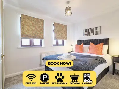 a bedroom with a bed and a sign that says book now at 4br 2bath House With Free Parking In Rivenhall in Rivenhall