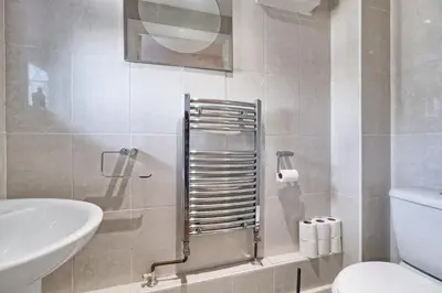 a bathroom with a toilet and a sink at 4br 2bath House With Free Parking In Rivenhall in Rivenhall
