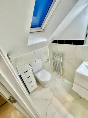 a bathroom with a white toilet and a window at cozy 1 bedroom flat near cambridge city centre in Milton