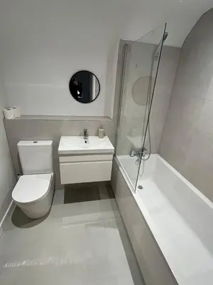 a bathroom with a toilet and a sink and a shower at Pineapple Cottage in Thorndon