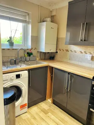 a kitchen with a sink and a washing machine at Modern 3 Bed House In Essex By DLuxoria Short Lets & Serviced Accommodation With Pet Friendly, Free WiFi & Free Parking in Basildon