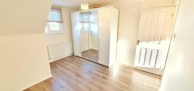 an empty room with a door and a wooden floor at Modern 3 Bed House In Essex By DLuxoria Short Lets & Serviced Accommodation With Pet Friendly, Free WiFi & Free Parking in Basildon