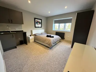 a bedroom with a bed and a window and a sink at Captivating 7 -Bed House in Waltham Abbey in Waltham Abbey