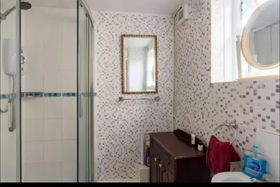 a bathroom with a shower and a sink and a mirror at Nice and spacious room in Chesterton