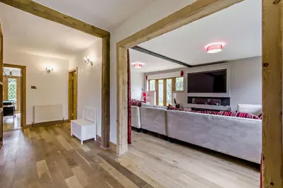 a large living room with a bar in the middle at Finest Retreats - The House at No 47 in West Wickham