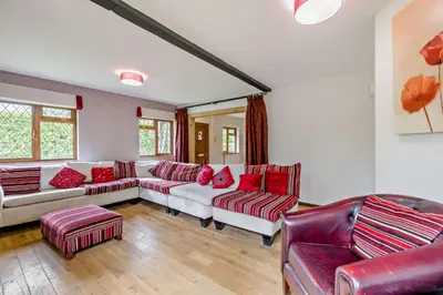 a living room with couches and red pillows at Finest Retreats - The House at No 47 in West Wickham