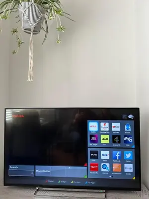 a flat screen tv sitting next to a wall at Place to stay up Ipswich near the train station, football stadium, waterfront in Ipswich