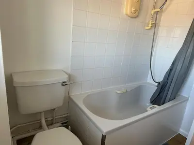 a bathroom with a toilet and a bath tub with at Place to stay up Ipswich near the train station, football stadium, waterfront in Ipswich