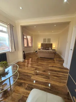 a living room with a couch and a glass table at One Bed and Bath in Rochford in Rochford