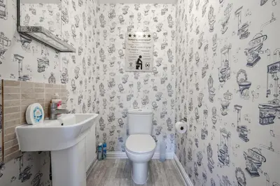 a bathroom with a white toilet and a sink at Cambridge 5 Bedrooms Sleeps 10 Free Parking 4 Bathrooms in Long Stanton