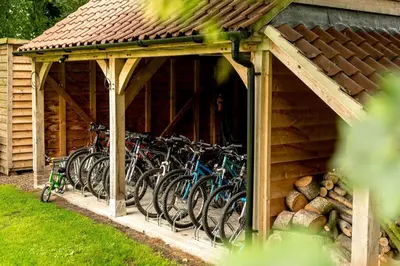 a group of bikes parked in a building at Hockham Grange in Hockham
