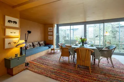 a living room with a table and chairs and a couch at Wodehouse, Eco House - Aldeburgh Coastal Cottages in Aldeburgh