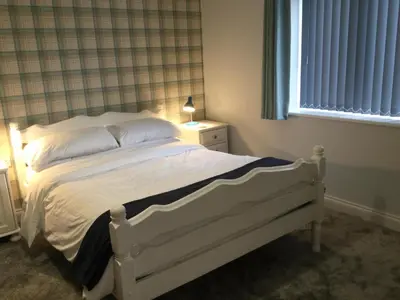 a white bed in a bedroom with a window at The Old Grain Store Bed & Breakfast in Pidley