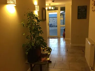 a hallway with a potted plant sitting on a table at The Old Grain Store Bed & Breakfast in Pidley