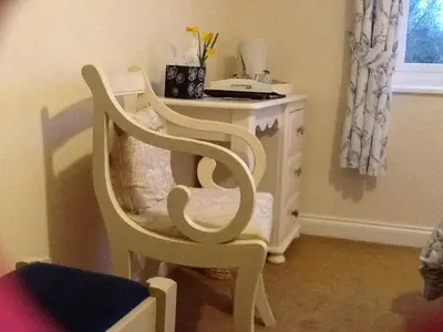 a white chair sitting in front of a desk at The Old Grain Store Bed & Breakfast in Pidley