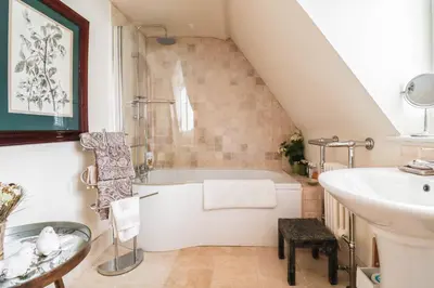 a bathroom with a bath tub and a sink at Beautifully Designed Cottage Free WiFi in Rivenhall