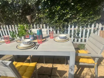 a white table with plates of food on it at Hurrell Cottage in Cambridge