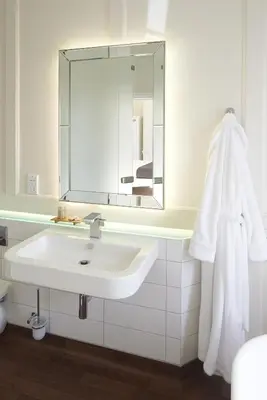 a white bathroom with a sink and a mirror at The Bell Inn Hotel in Horndon on the Hill