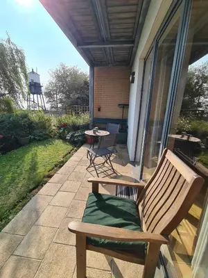 a patio with two chairs and a table on a porch at Alices’s Beachside Haven in Harwich