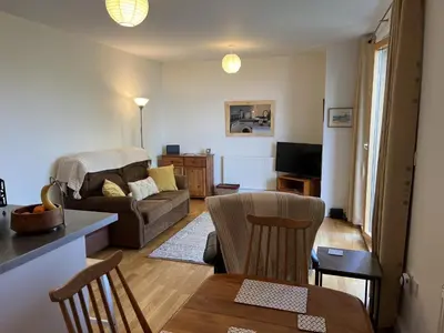 a living room with a couch and a table at Alices’s Beachside Haven in Harwich