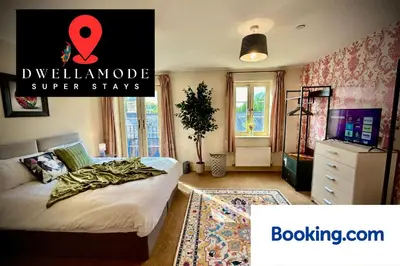 a bedroom with a bed with a red sign on it at 5 Bedroom House - DISC0UNTS - Parking, Contractors, Crew, Group, Family in Colchester