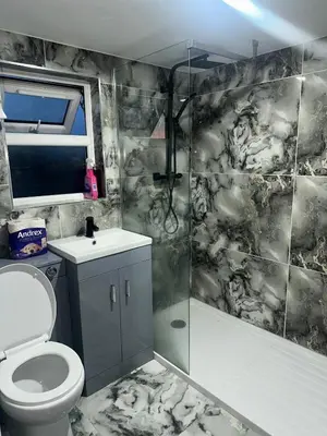 a bathroom with a shower and a toilet and a sink at Modern Studio Flat In A Guest House In Basildon in Basildon