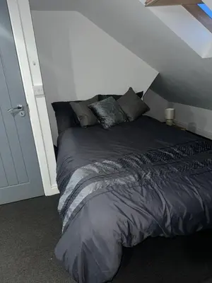 a large bed in a room with a attic at Modern Studio Flat In A Guest House In Basildon in Basildon