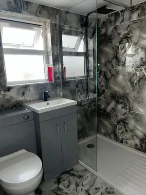a bathroom with a toilet and a sink and a shower at Modern Studio Flat In A Guest House In Basildon in Basildon