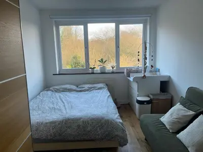 a bedroom with a bed and a window at Lea Valley Nature Reserve Bright Home with Private Garden - 40 min to London by Train in Nazeing