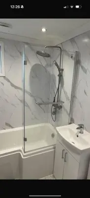 a bathroom with a shower and a sink and a toilet at Paramount Luxe Loft- 3 bedrooms, 4 beds cosy home in Laindon