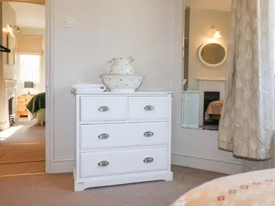 a white dresser with a bowl on top of it at Holm Oak Lodge in Clacton-on-Sea