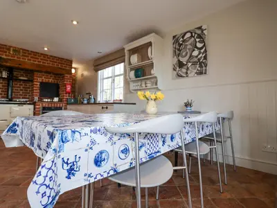 a kitchen with a blue and white table and chairs at Holm Oak Lodge in Clacton-on-Sea