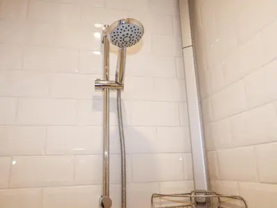 a shower with a shower head in a bathroom at Holm Oak Lodge in Clacton-on-Sea