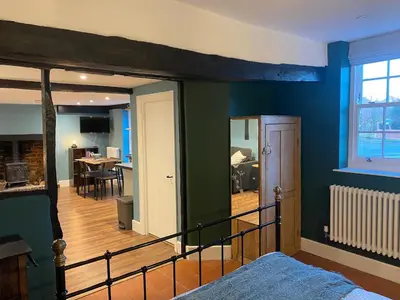 a bedroom with blue walls and a bed in a room at The Old King Bill in Fenstanton