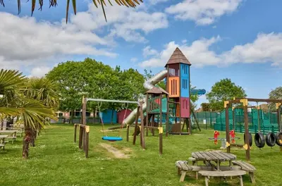a playground with a slide in a park at Highfield Grange Holiday Park Clacton in Little Clacton