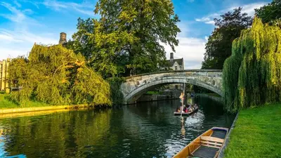 a boat traveling down a river under a bridge at Spacious 3-Bed Townhouse Florence Villa Near River & City in Chesterton