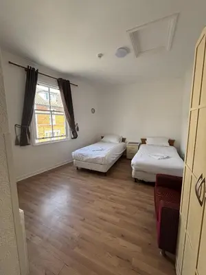 a room with two beds and a window at Ipswich Inn in Ipswich