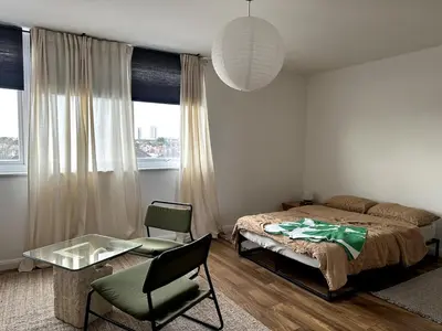 a bedroom with a bed and a table and a chair at Flat-on-Sea in Southend-on-Sea