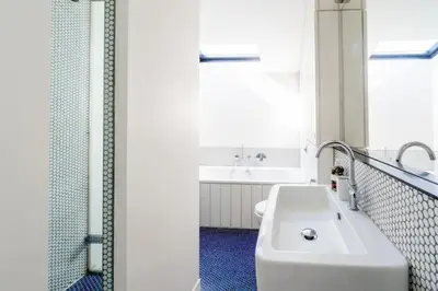 a bathroom with a white tub and a sink at Edinburgh House in Aldeburgh