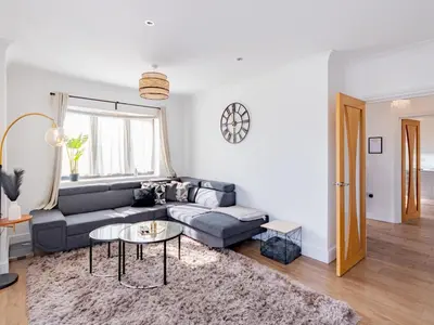 a living room with a couch and a table at Hawkwell Retreat 5 Bedroom home Hockley - Pass the Keys in Hawkwell