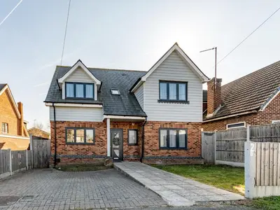 a brick house with a fence in front of it at Hawkwell Hideaway Large 4 bedroom Home Hockley - Pass the Keys in Hawkwell