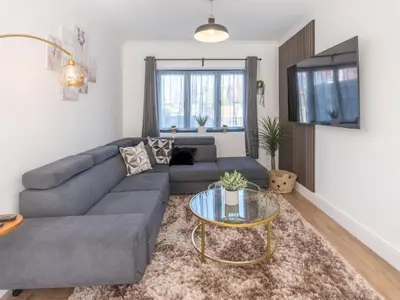 a living room with a couch and a glass table at Hawkwell Hideaway Large 4 bedroom Home Hockley - Pass the Keys in Hawkwell